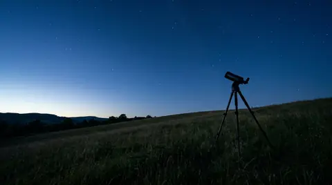 AI-generated image of a telescope on a tripod under a starry night sky